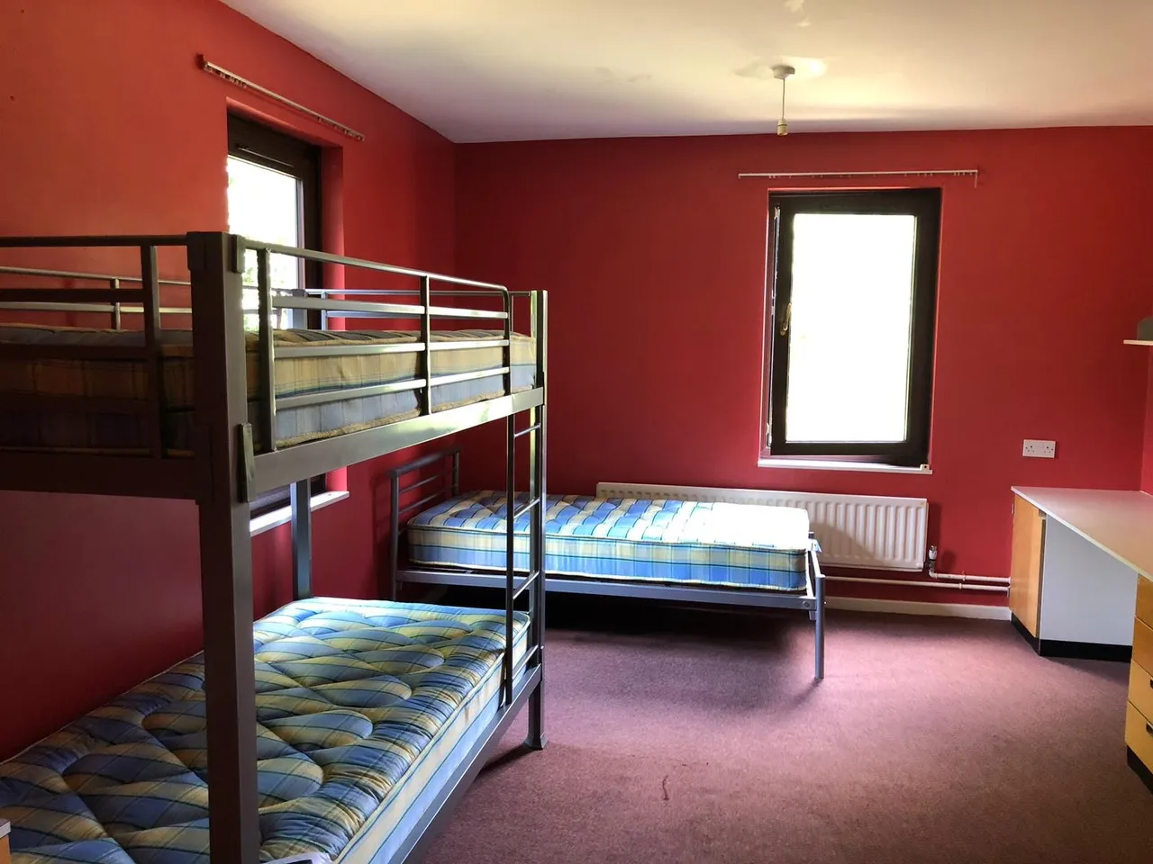 Another residential bedroom with bunk beds